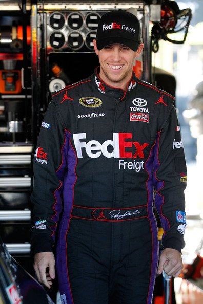 Denny Hamlin smiling in the garage