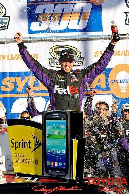 Denny Hamlin gets out of his car in victory lane