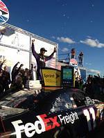 Denny gets out of his car in victory lane