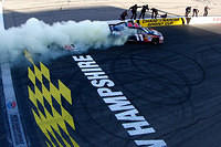 Denny Hamlin doing a burn out past his crew