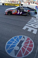 Denny Hamlin burnout with the Checkered Flag